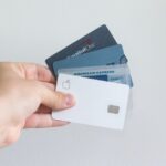 person holding credit cards
