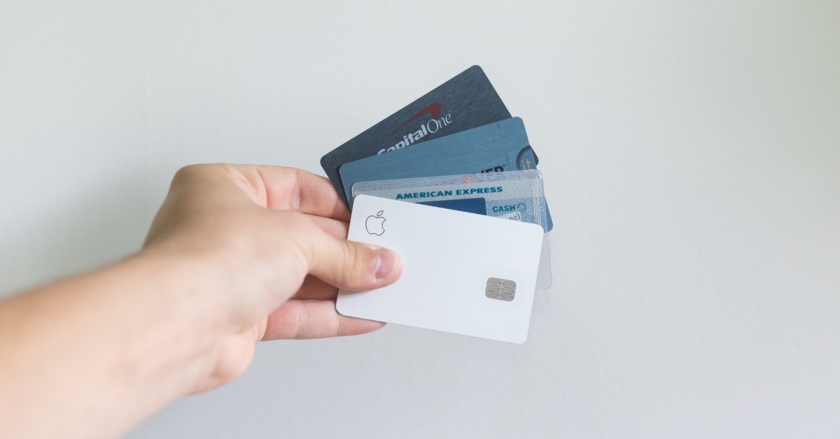 person holding credit cards
