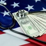 american flag with money and a stethoscope