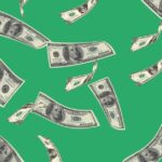 money falling from sky on green background