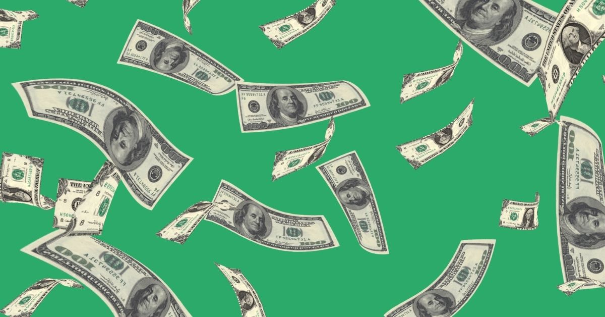 money falling from sky on green background