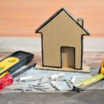 cardboard house with screws wall anchors and tools