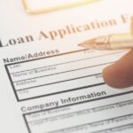 person signing a loan application
