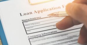 person signing a loan application