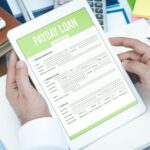person holding a payday loan application form in their hands