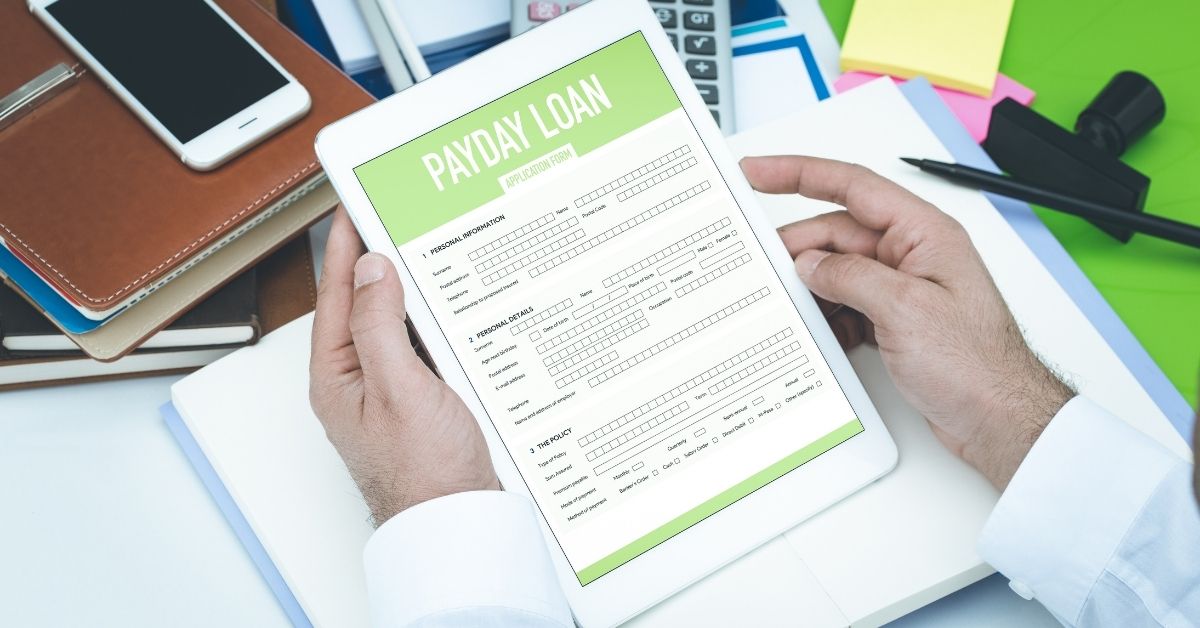 person holding a payday loan application form in their hands