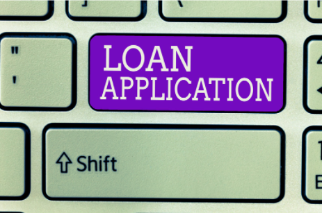 A computer keyboard with a key added that says "Loan Application." This implies that the article is about loans.