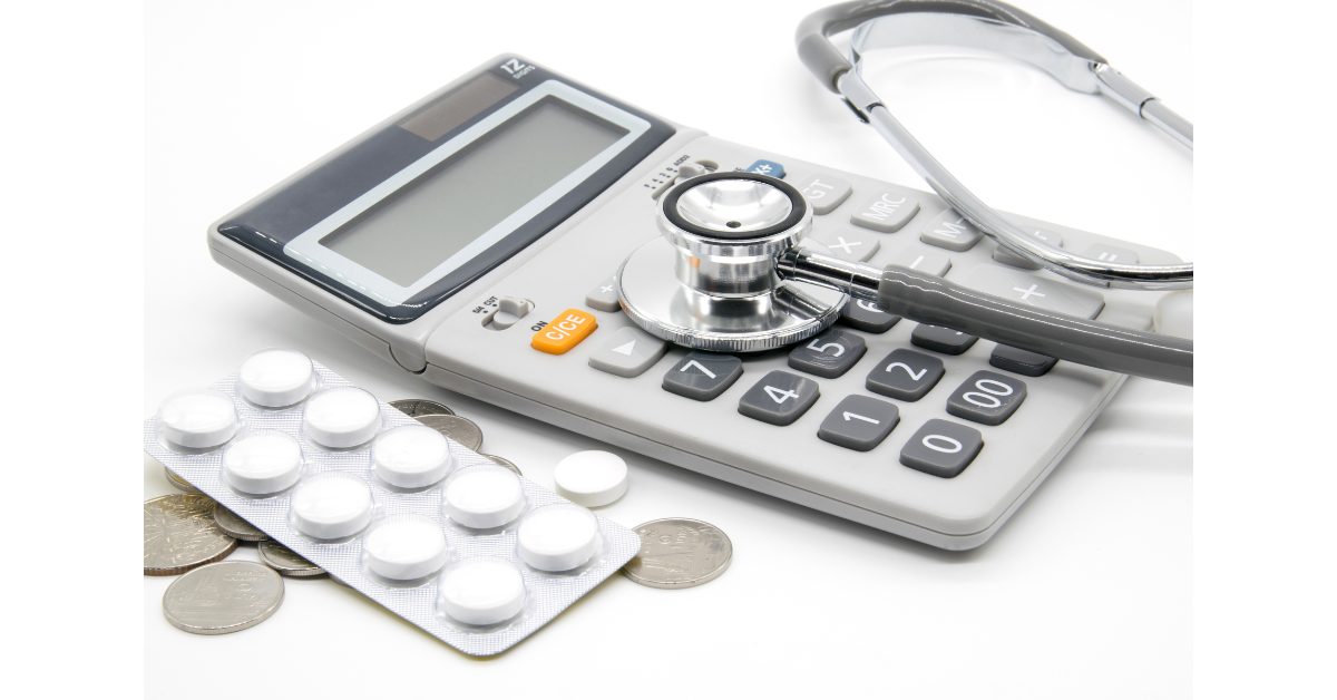 Medical bill related items calculator, stethoscope, pills, and coins