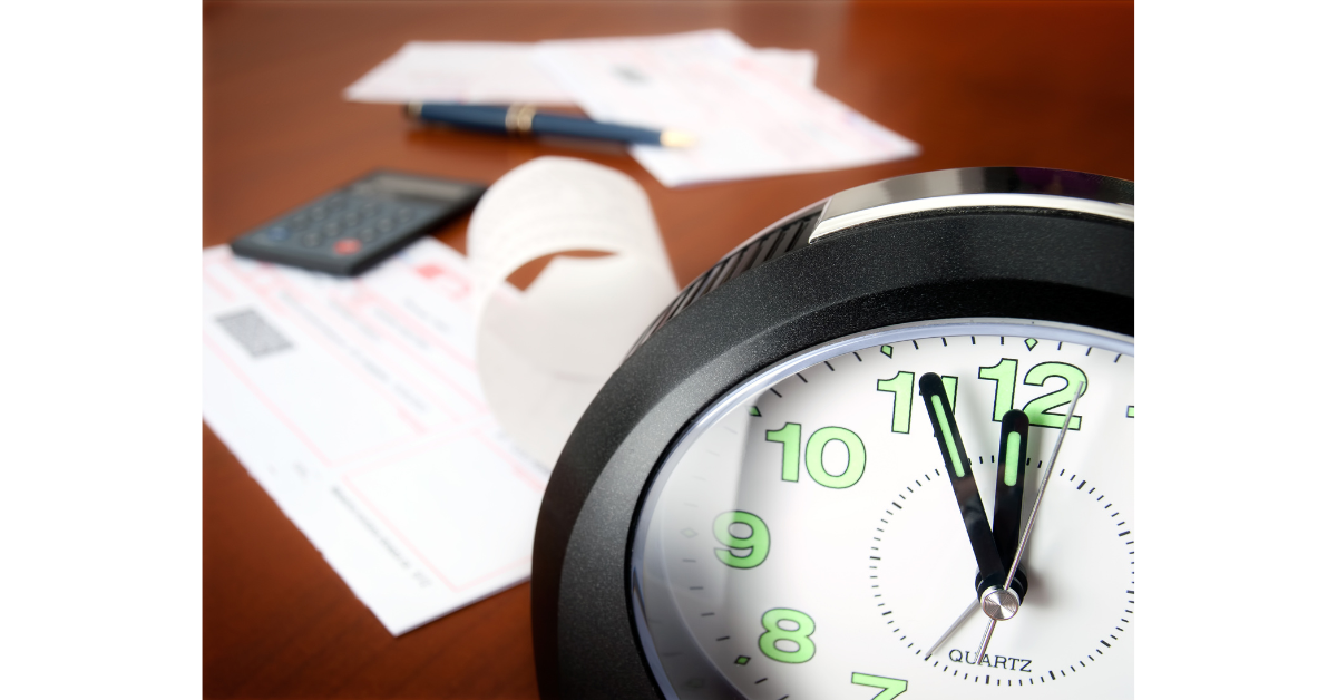 Clock and bills showing paying on time