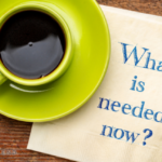 A yellow cup and saucer with coffee sits atop a napkin that has "What is needed now?" typed on it in a blue serif font. This implies that the article relates to how "I need money right now, what should I do?"
