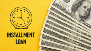Some $100 bills are spread out against a yellow background, with the words “Installment Loan” and a vector image of a clock.